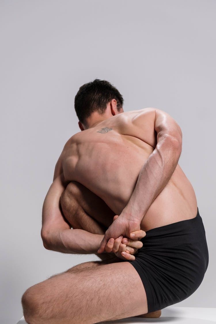 A Contortionist Stretching His Arms