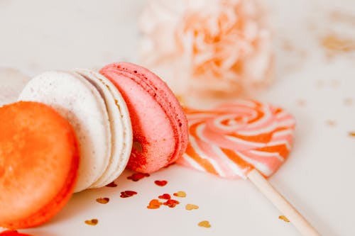Macarons and Lollipop on White Surface