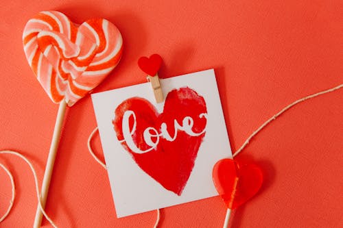 Free Heart Shaped Items on Red Surface Stock Photo