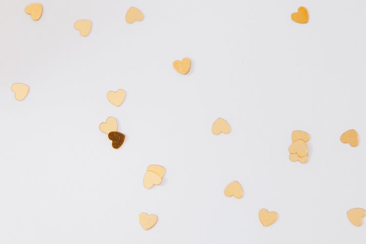 Close-up Of Scattered Gold Heart Shaped Confetti 