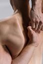 A Shirtless Man Hands on His Back