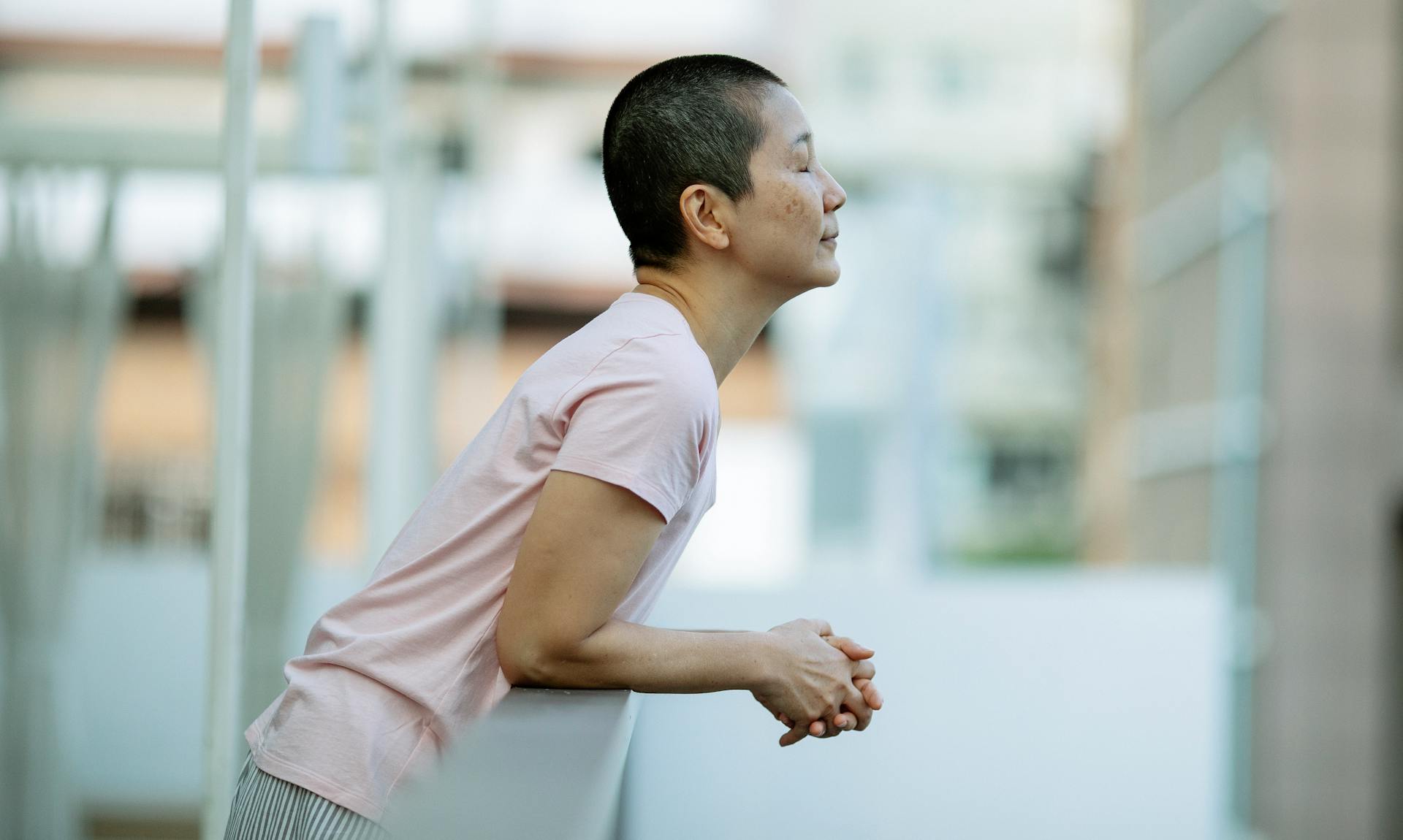 Asian woman with eyes closed suffering from breast cancer