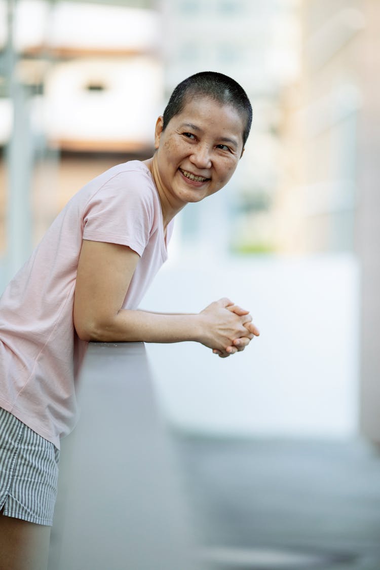 Cheerful Short Haired Asian Woman With Breast Cancer Smiling