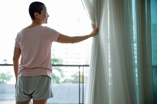 An optimistic woman opens curtains, welcoming a hopeful morning indoors, symbolizing positivity and recovery.