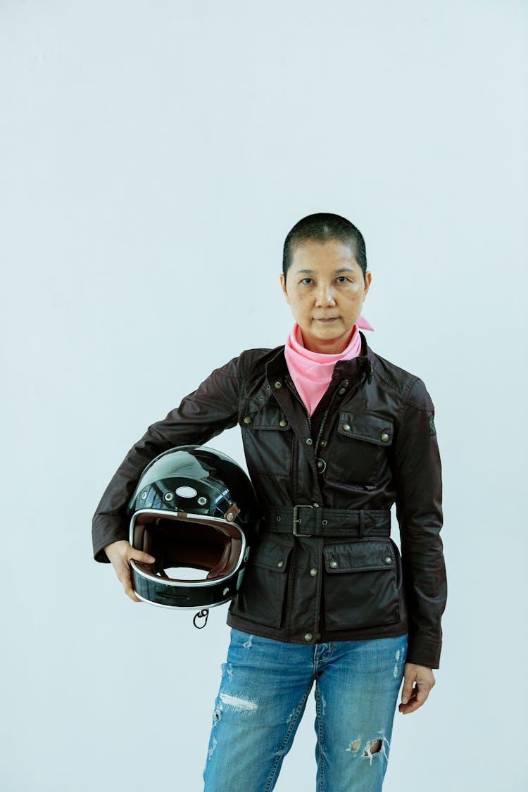 Confident Asian Woman Standing With Black Motorcycle Helmet