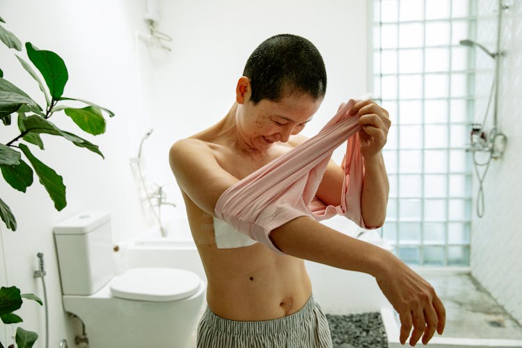 Senior Asian Woman Wearing T Shirt After Breast Operation