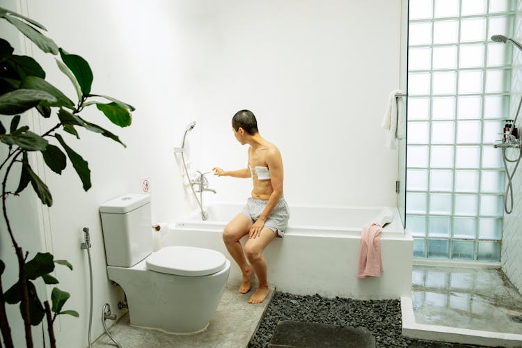 Pensive Woman Sitting In Bathroom After Breast Operation