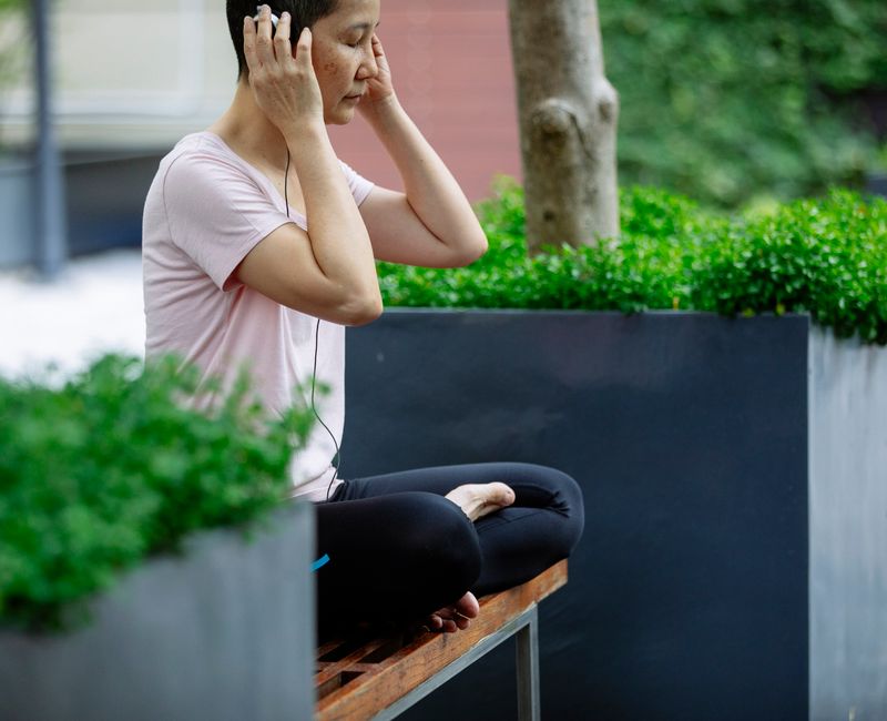 A serene woman practicing mindfulness outdoors