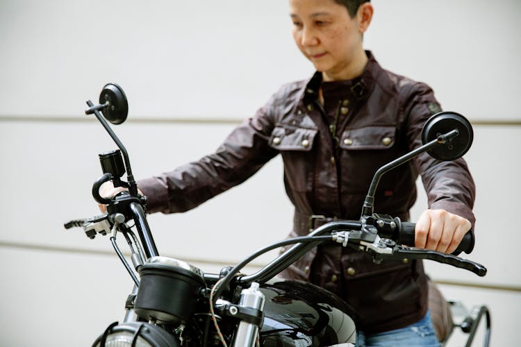 Ethnic Woman On Motorbike In Street