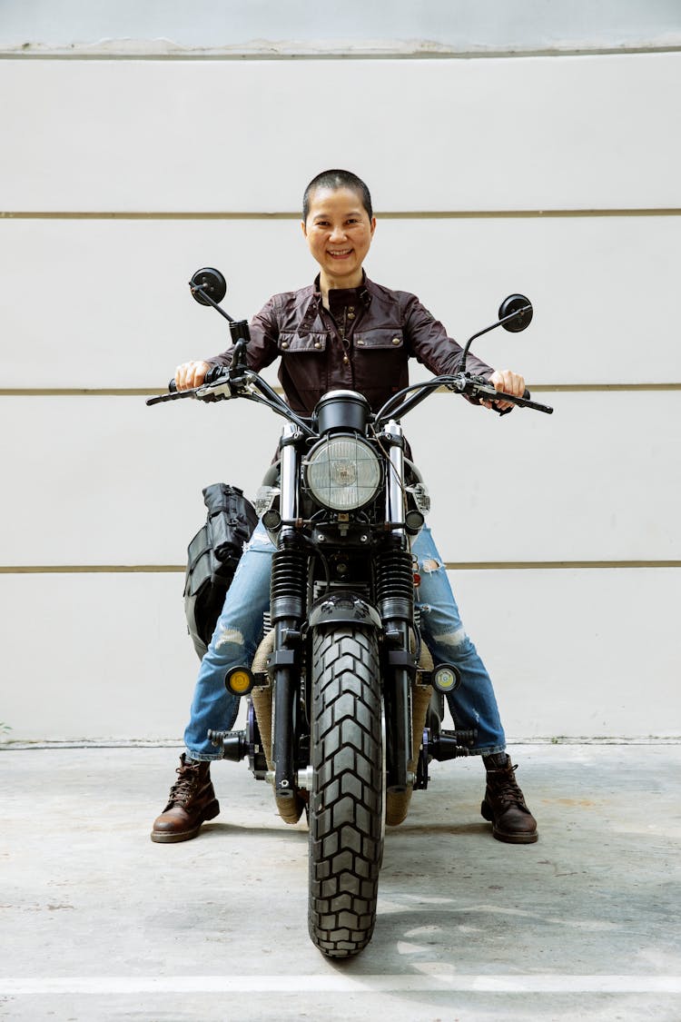 Happy Asian Lady On Motorcycle In Street On Road