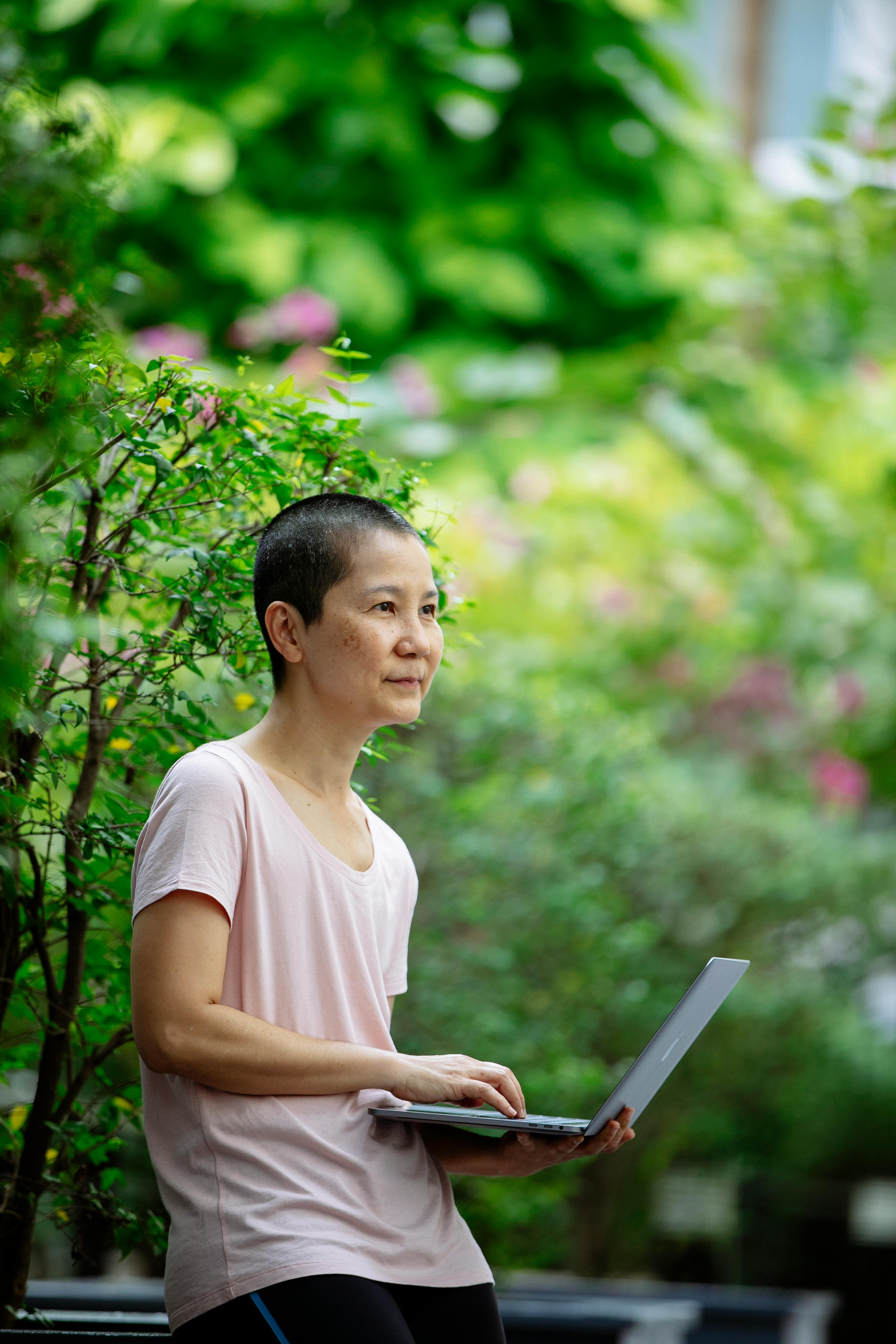 ethnic female with laptop in park