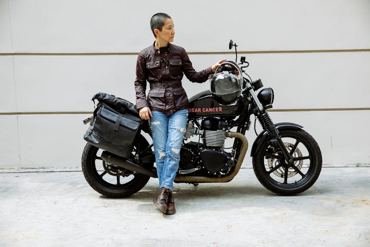 Confident Asian Lady Near Motorcycle On Road In Street