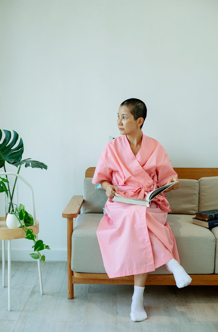 Asian Woman In Pink Robe Suffering From Breast Cancer Resting