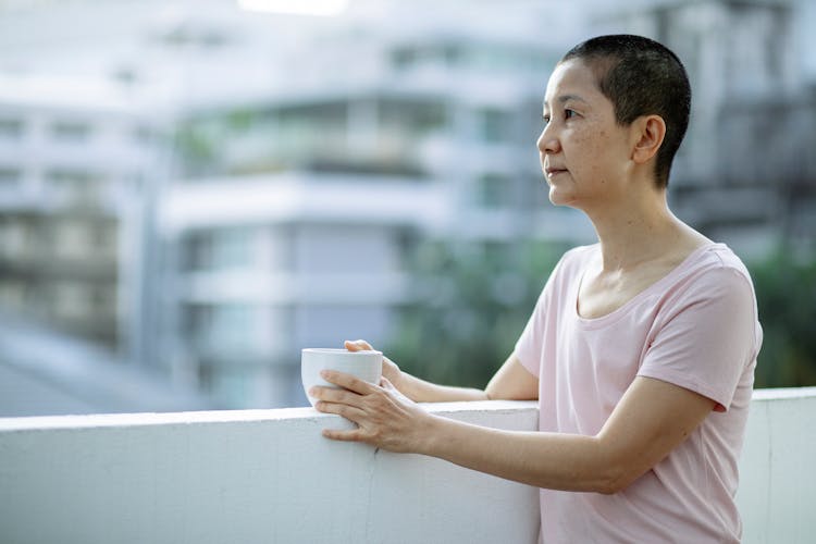 Sick Asian Woman With Cup Of Tea Suffering From Cancer