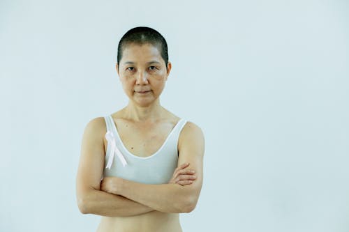 Asian woman with arms folded and breast cancer