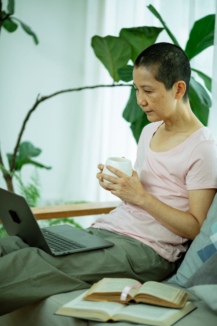 Exhausted Asian Woman With Short Hair Using Laptop