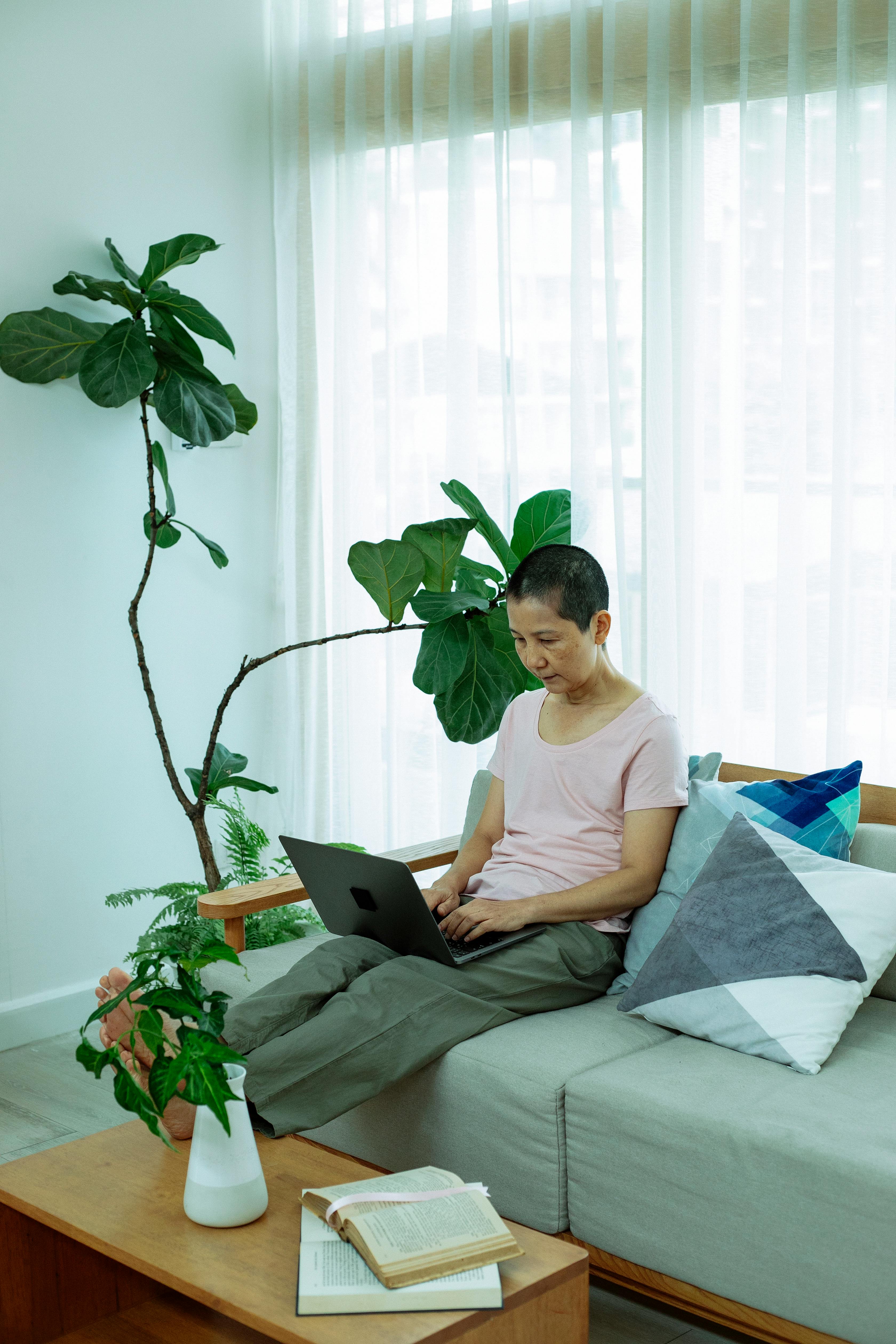 adult asian female freelancer using laptop at home