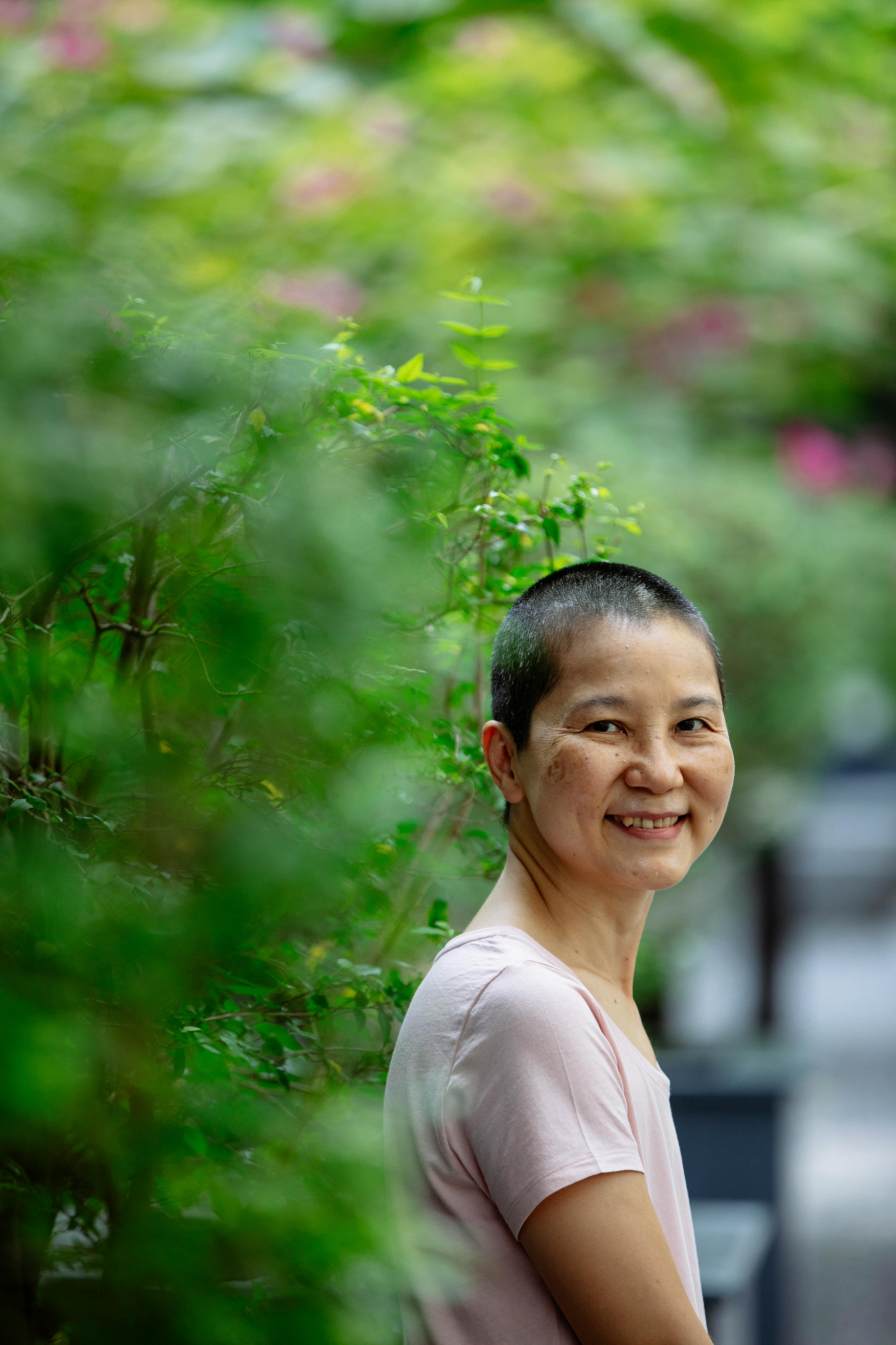 positive ethnic woman smiling while resting in park