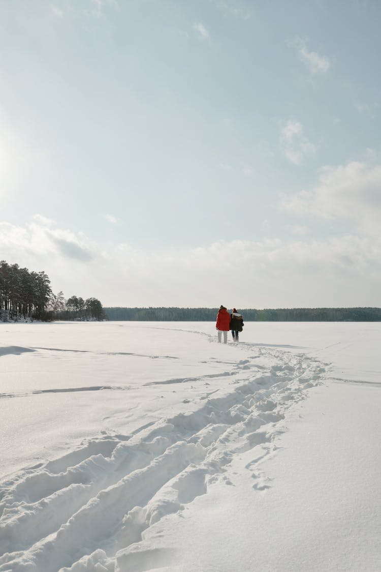 A Couple Walking Outdoor In The Snow