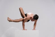 A Topless Man Doing an Acrobatic Exercise