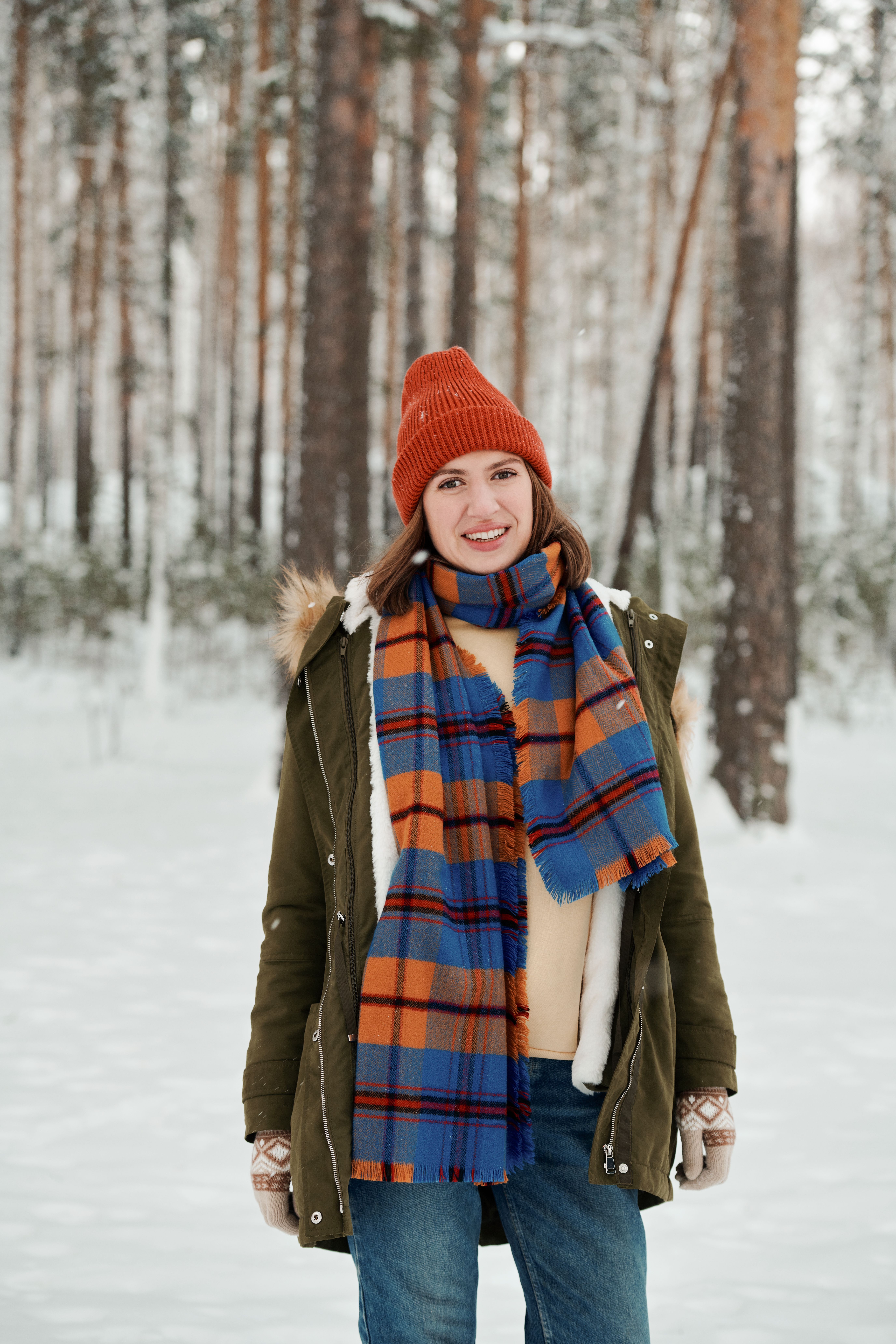 Woman in jeans with oversized blanket scarf