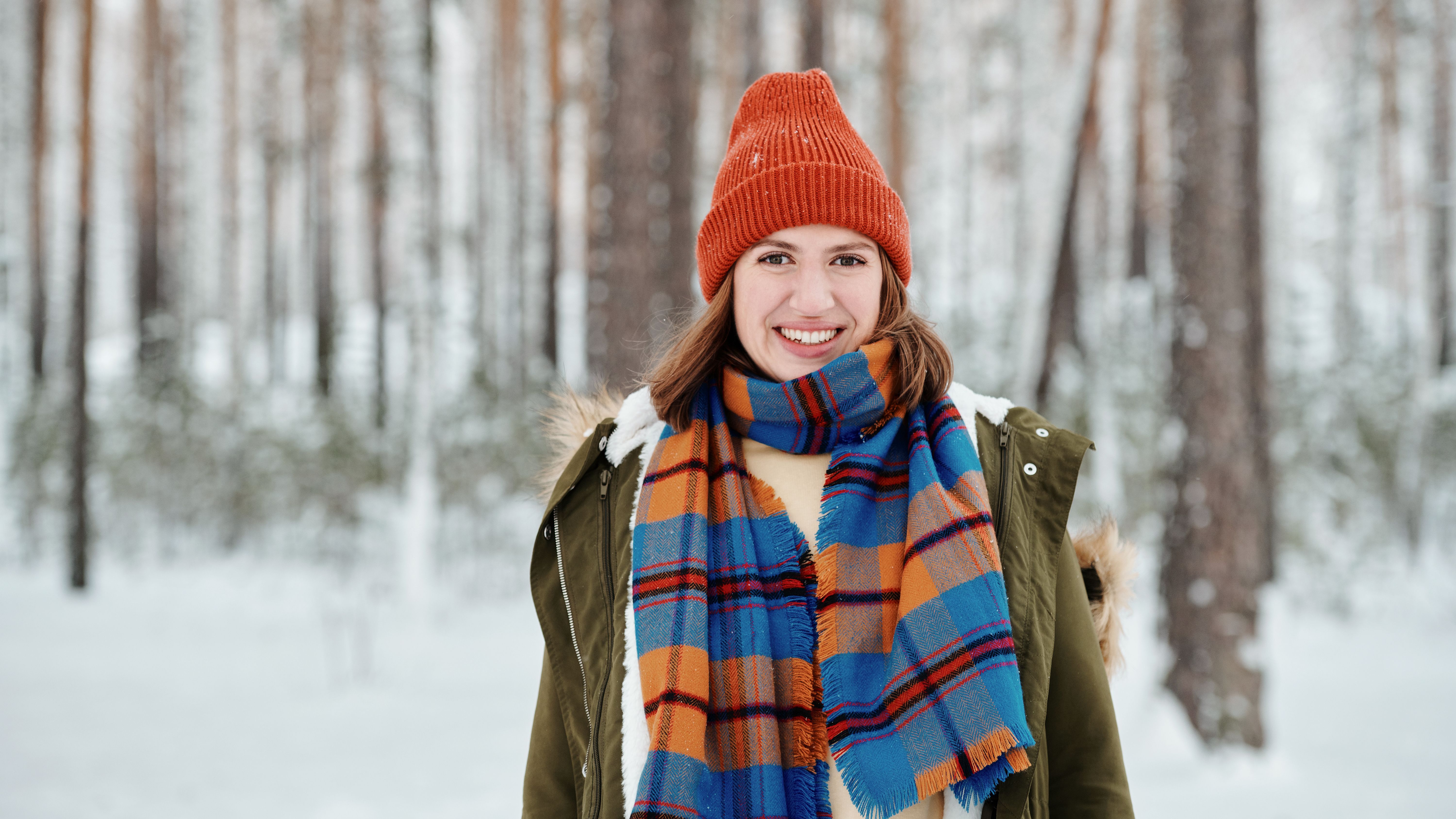 A traveler wearing layered clothing suitable for Portugal's variable coastal weather.