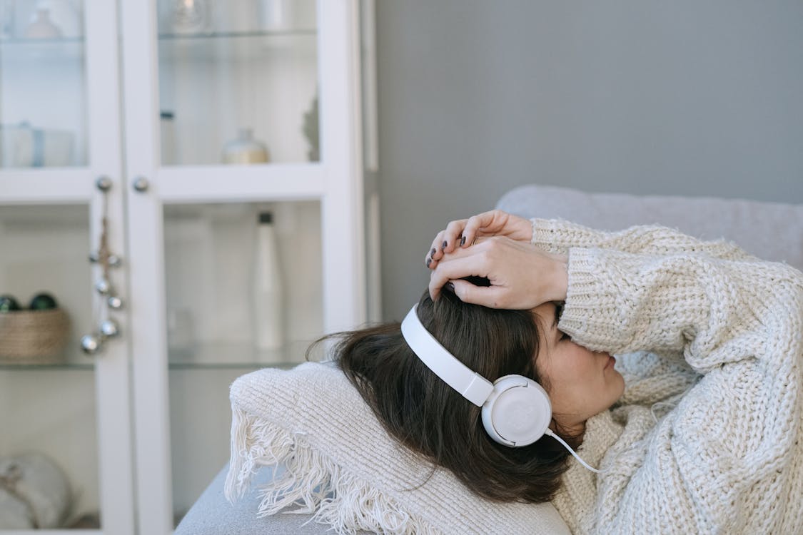 Free Woman in White Sweater Wearing White Headphones Stock Photo