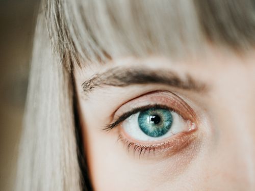 Free A macro shot of a blue human eye highlighting the detailed iris and eyelashes. Stock Photo