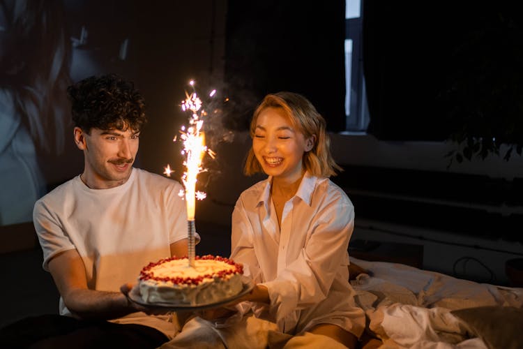 Romantic Couple Holding A Birthday Cake