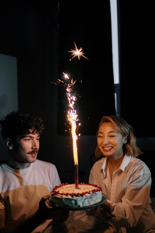 Man and Woman Holding a Birthday Cake