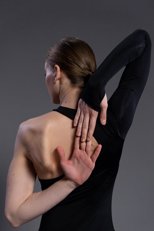 Woman stretching arms for good flexibility of her bicep stock