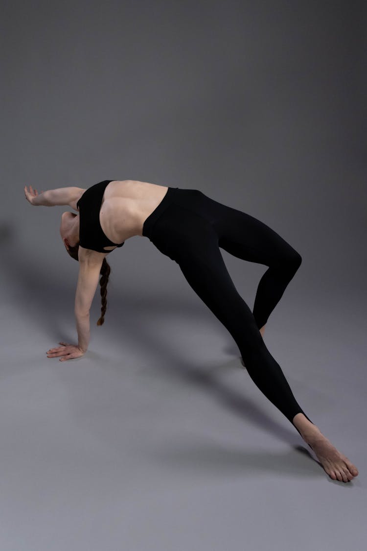 Woman Doing Backbend On The Floor