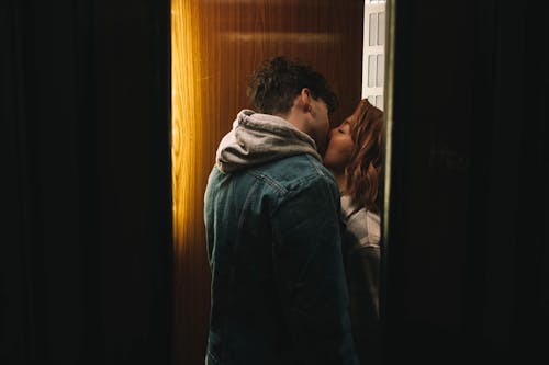 Free Beautiful Couple Kissing on the Doorway Stock Photo