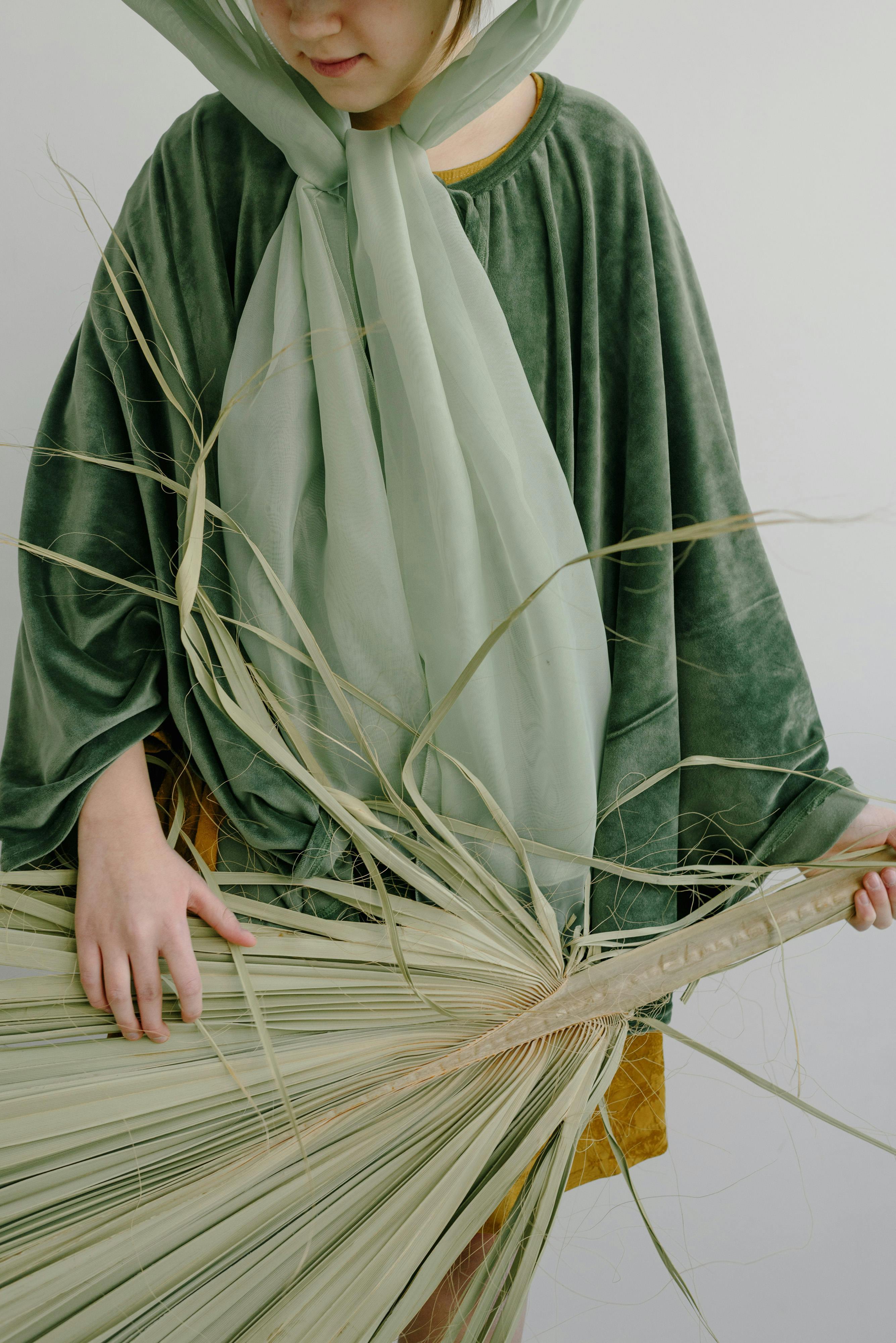 person holding a palm leaf