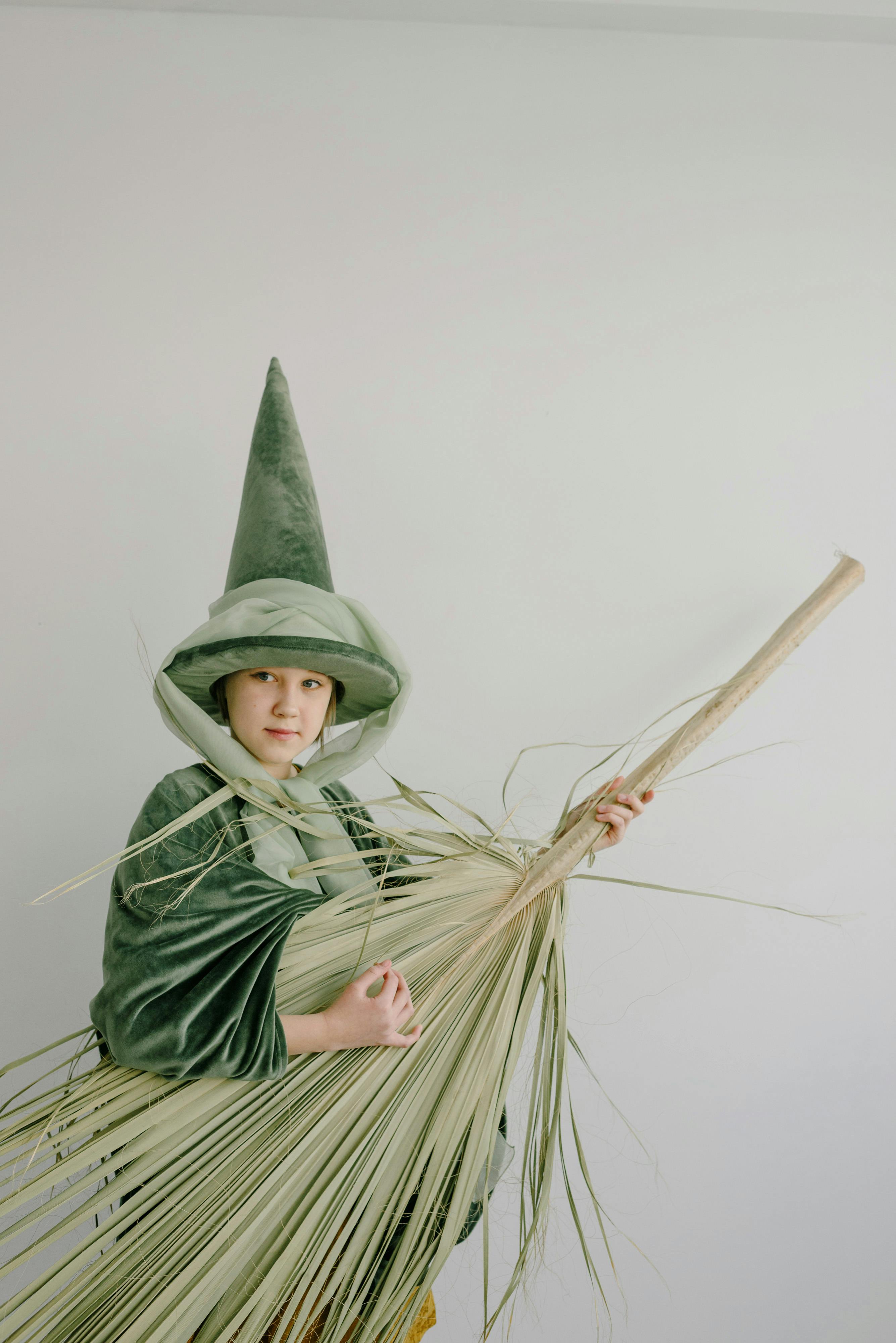 girl wearing fairy costume holding a palm leaf