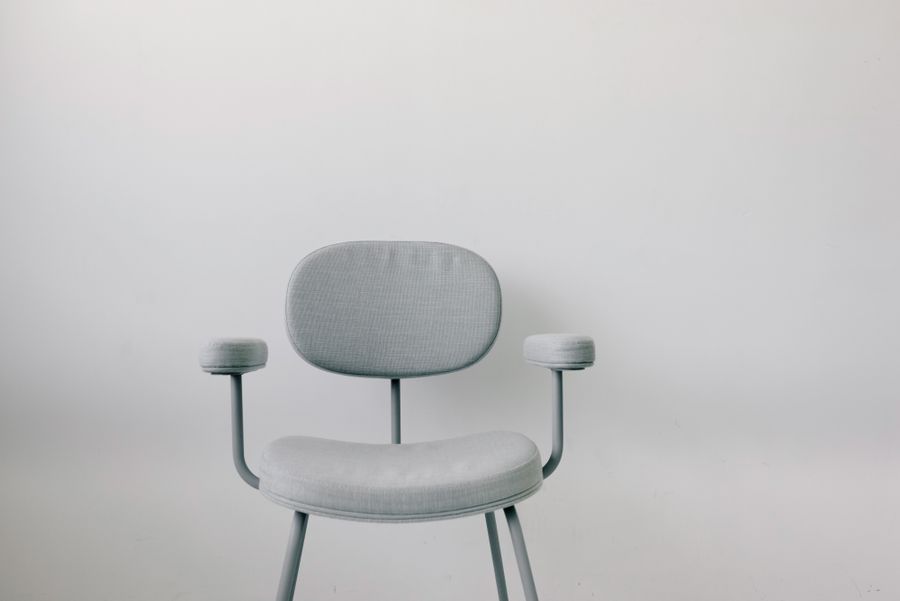 Pale grey lounge chair with slim metal arms — photo by Ksenia Chernaya on Pexels