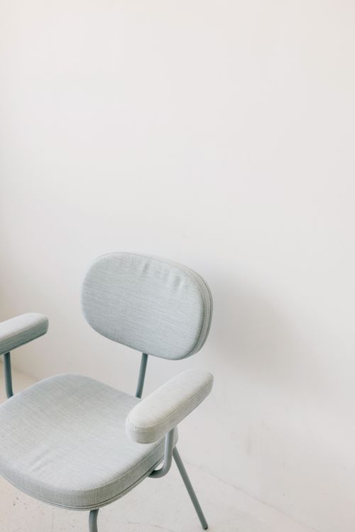 Free Modern armchair with soft fabric in a minimalist interior setting. Stock Photo