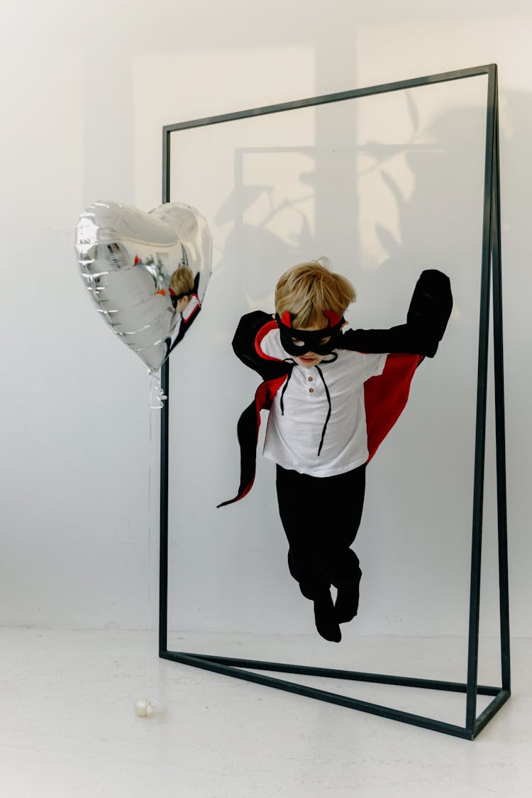 A Boy Jumping Through A Frame