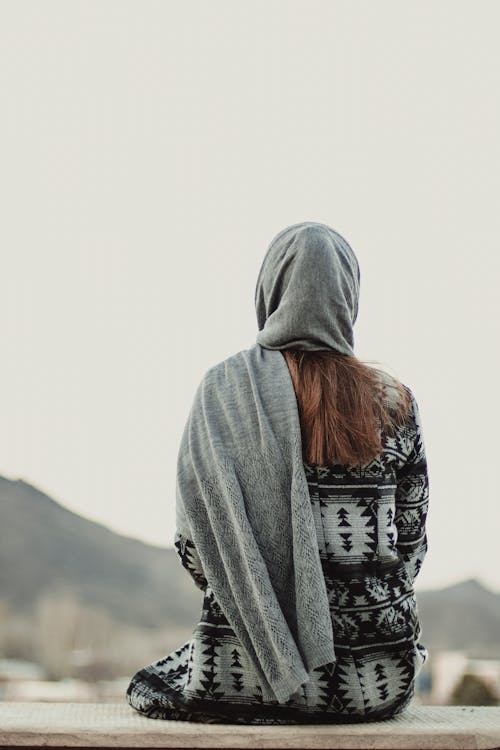 Free Back View of a Sitting Woman with Headscarf Stock Photo
