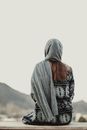 Back View of a Sitting Woman with Headscarf
