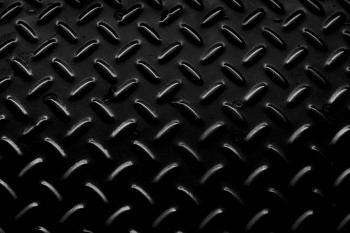 Free Textured full frame background of black metal surface with oval bulging pimples making relief Stock Photo