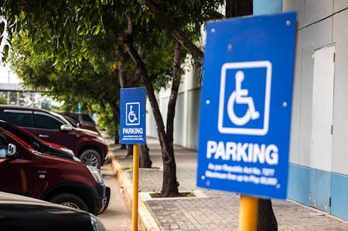 Disabled parking sign on street with transport