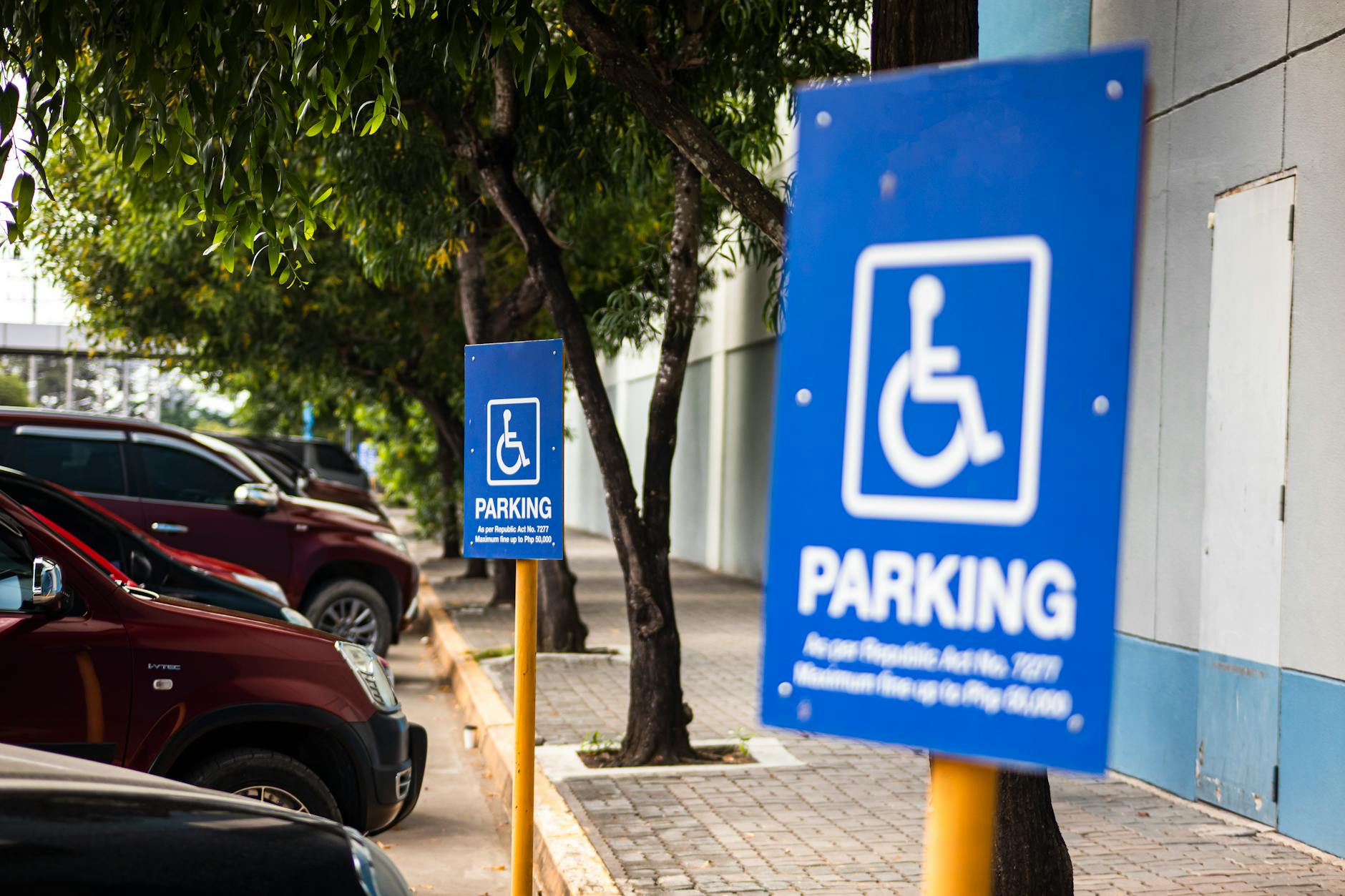 Disabled parking sign on street with transport