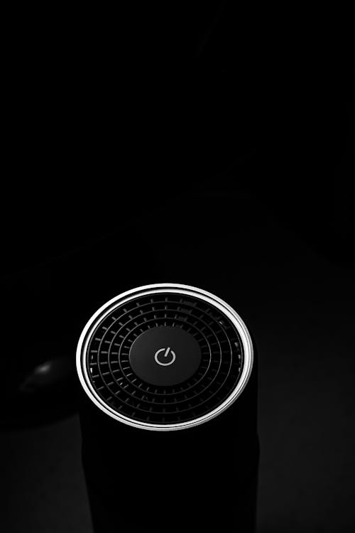 Free From above of modern portable speaker for music with start button in black studio Stock Photo