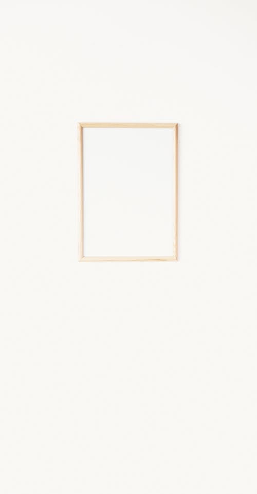 A Brown Wooden Frame Hanging on White Wall