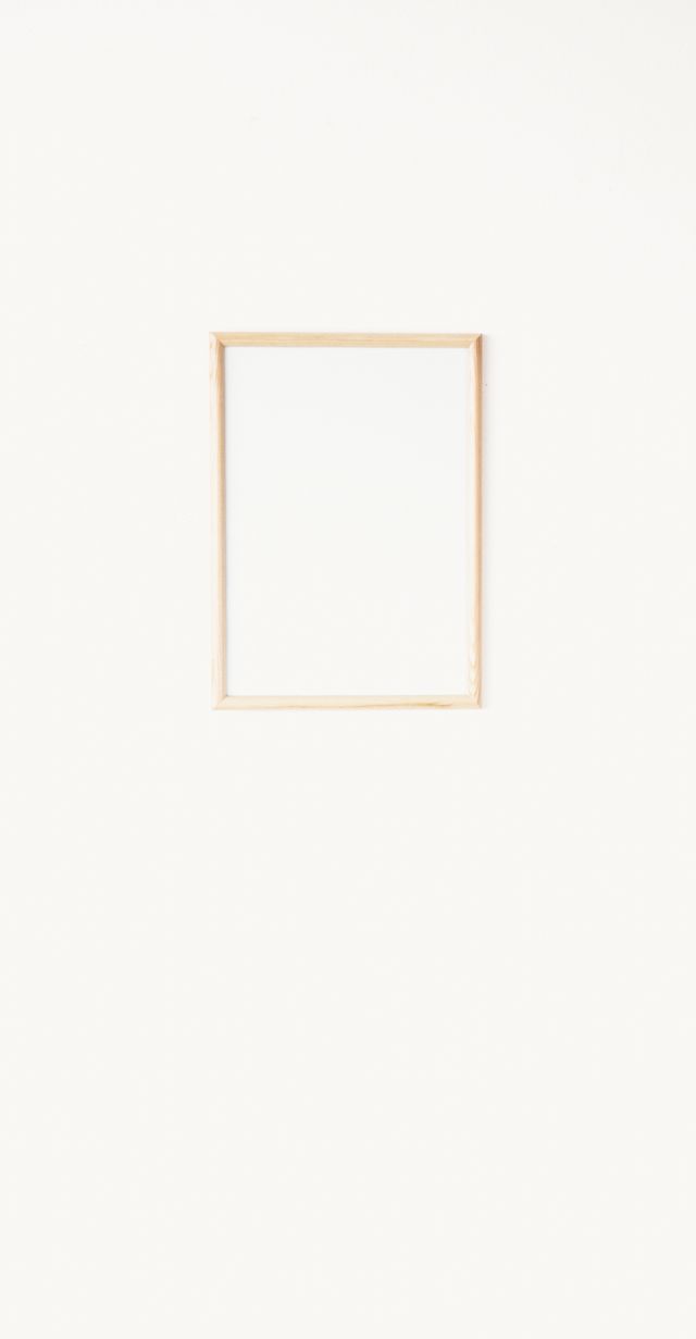 Slim mounted frame on a pale plaster wall — Artem Podrez on Pexels
