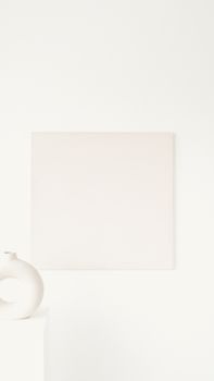 A minimalist interior featuring abstract art and a modern vase on a white surface.