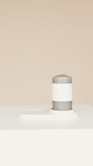 Grey pillar candle on a minimalist holder by Artem Podrez on Pexels