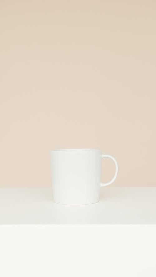 White Ceramic Mug on White Table