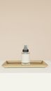 White and Silver Bottle on Brown Wooden Tray